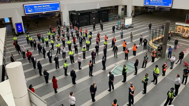 Staff holding the one-minute silence