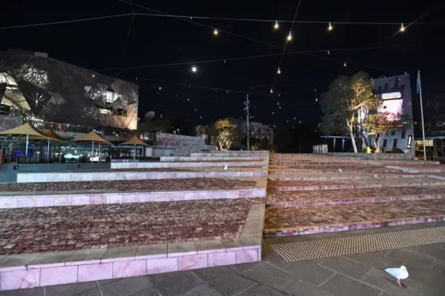 An empty Federation Square is seen before a citywide curfew is introduced in Melbourne