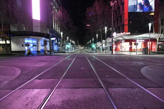 A general view of a deserted Bourke Street after a citywide curfew is introduced in Melbourne, Victoria