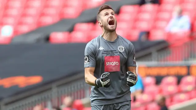 Harrogate keeper James Belshaw celebrates making a save