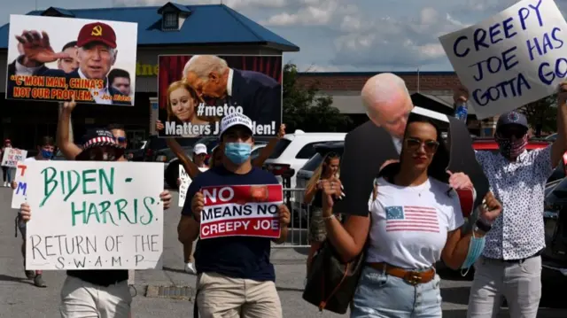 Trump supporters hold anti-Biden placards as they walk by the Democratic National Convention site at the Chase Center in Wilmington, Delaware, on August 20, 2020