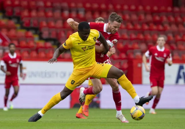 Livingston captain Marvin Bartley battles with Marley Watkins