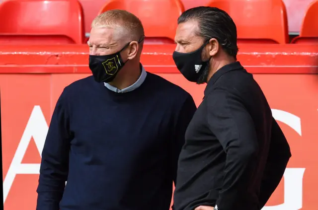 Managers Gary Holt and Derek McInnes exchange a few muffled words