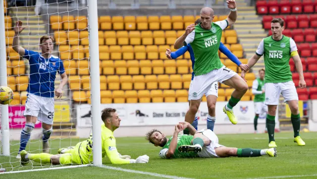 Christian Doidge bundles the ball in but it had struck the arm of the Hibs striker seconds before