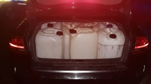 Boot full of fuel drums