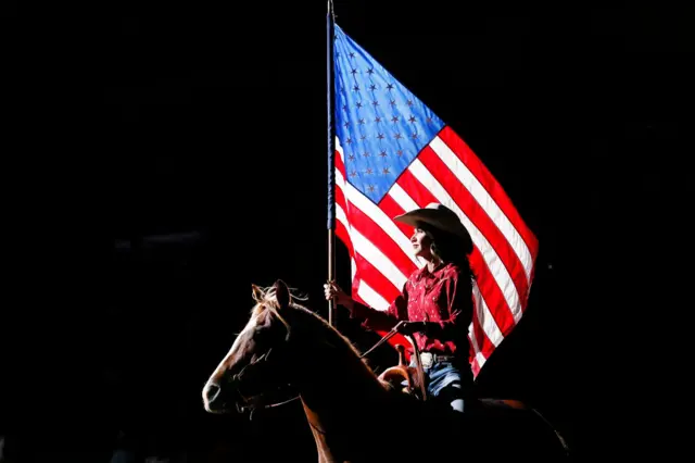 Noem, a former rancher, rides a horse during a rodeo in South Dakota last month