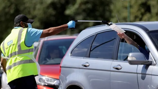 NHS employee taking a test from a person in a car