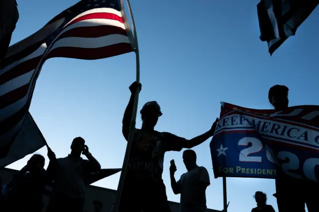 Far right protesters wave American flags and banners advocating for the reelection of President Donald Trump during a rally at Gresham City Hall on August 26, 2020 in Gresham, Oregon