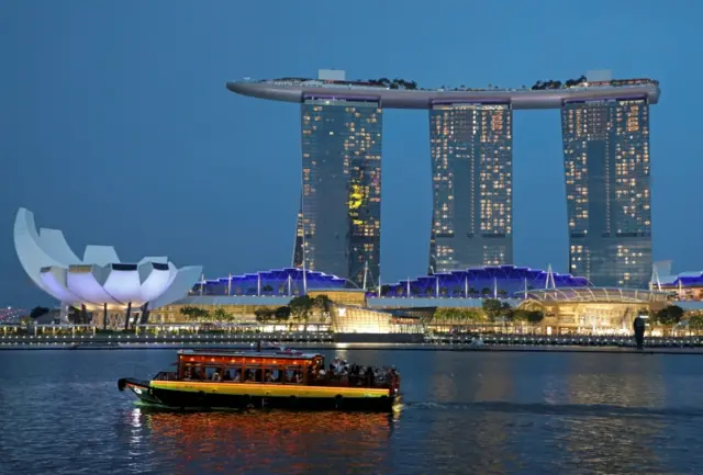 A tourist boat passes by the Marina Bay Sands hotel in Singapore