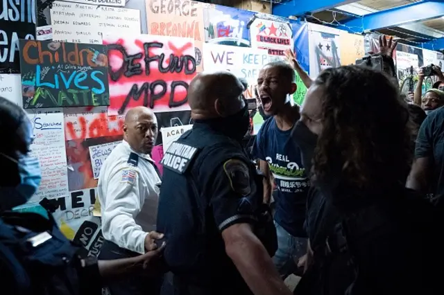 Demonstrators confront police officers during a rally to protest US President Donald Trump's acceptance of the Republican National Convention nomination at Black Lives Matter plaza across from the White House on August 27, 2020