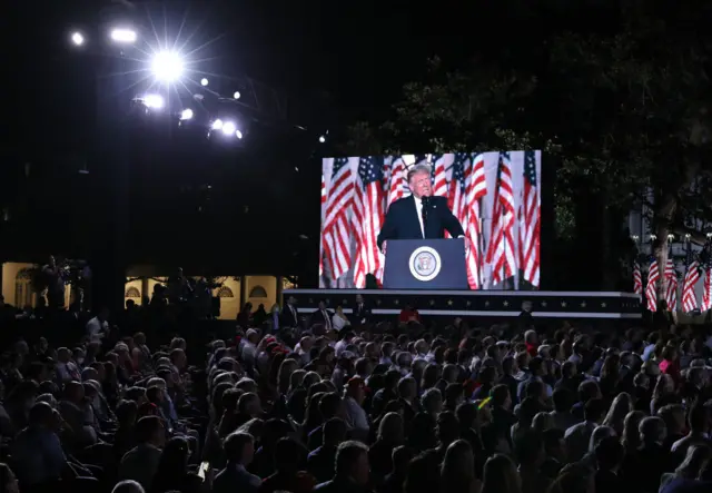 A screen displays a video of U.S. President Donald Trump as he delivers his acceptance speech for the Republican presidential nomination on the South Lawn of the White House August 27, 2020 in Washington, DC