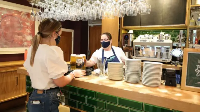 Drinks are served during the reopening of The Old Stables Restaurant at Allerton Manor Golf Club, Liverpool, as coronavirus lockdown restrictions are eased across England