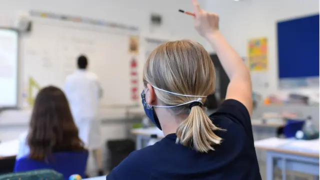 Child in classroom with face mask on