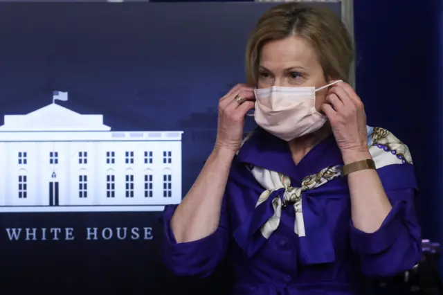 Dr Deborah Birx, the White House coronavirus response coordinator, puts on a protective face mask