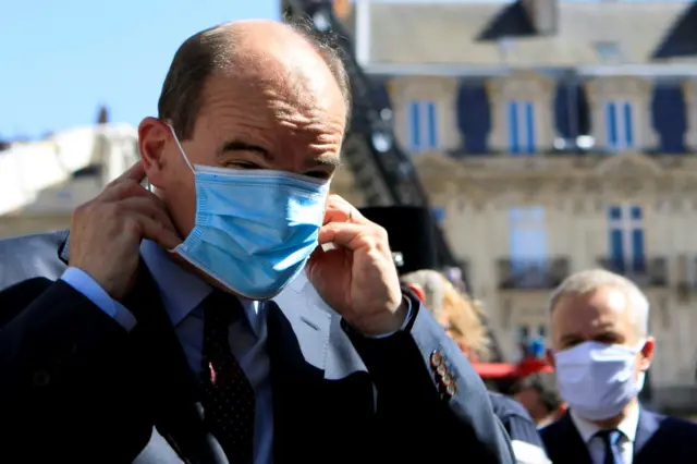 French Prime Minister Jean Castex adjusts his protective mask before taking to the media in Nantes in July