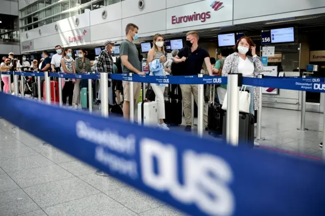 Passengers wear face masks at Dusseldorf Airport