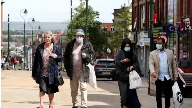 People walking along a street in Manchester