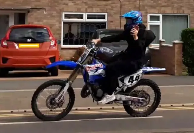 Motorcyclist driving along Southchurch Drive in Clifton, Nottinghamshire