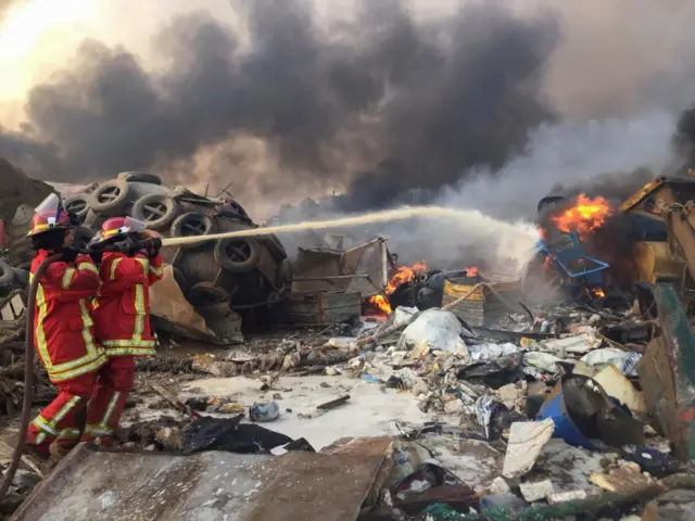 Firefighters spray water at a fire after the explosion in Beirut, Lebanon August 4, 2020.