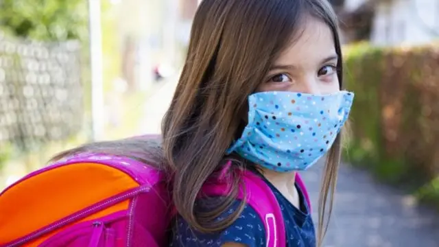 A school pupil in a face covering