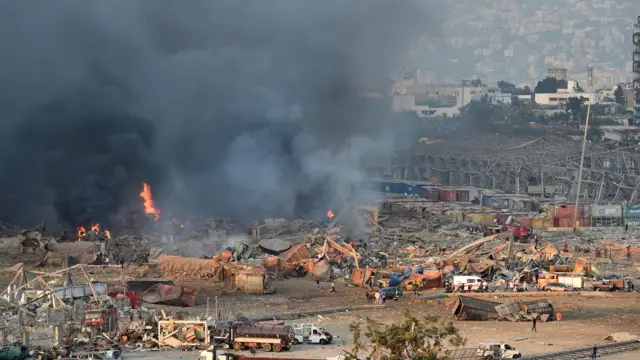 A general view of the harbor area with smoke billowing from an area of a large explosion.