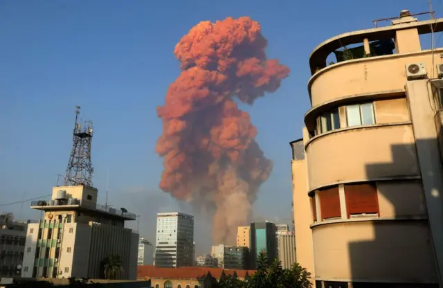 Smoke rises from the ground of the explosion