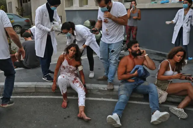 Wounded people are pictured outside a hospital following an explosion in the Lebanese capital Beirut on August 4, 2020