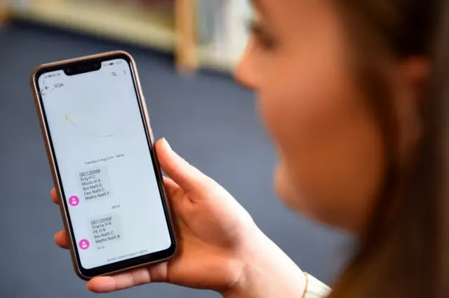 A pupil receives her results by text message