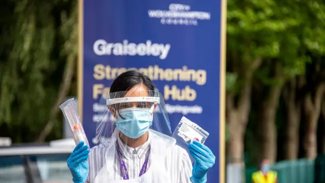 Woman holding test kit