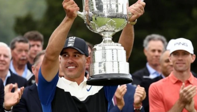 Brooks Koepka lifts the Wanamaker Trophy after winning the US PGA Championship in 2019