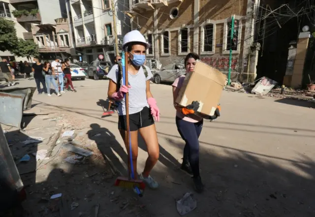 Volunteers clean the streets, following Tuesday"s blast in Beirut"s port area