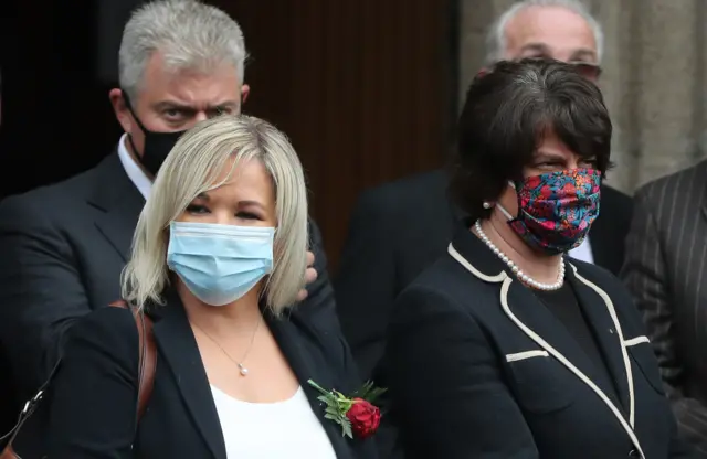 Deputy First Minister Michelle O"Neill and First Minister Arlene Foster outside St Eugene's Cathedral