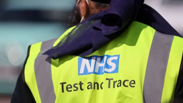 An NHS employee is seen at a testing centre near the Crown and Anchor pub