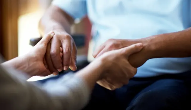 Patient holding hands