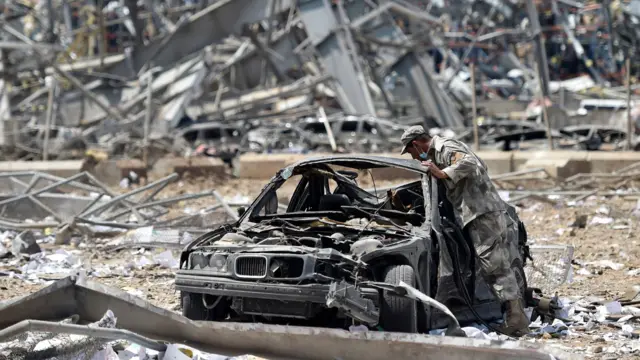 A Lebanese soldier inspects a damaged car three days after explosions that hit Beirut port, in Beirut, Lebanon, 07 August 2020.