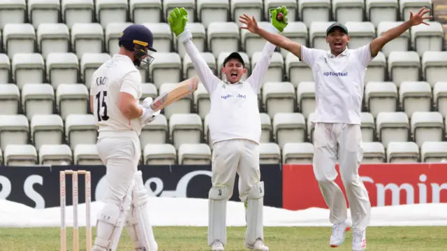 Harry Swindells and Ben Mike appeal for a catch behind from Danny Lamb