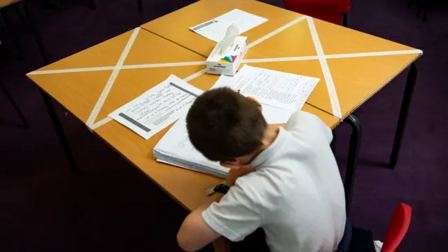 A child studies at a table