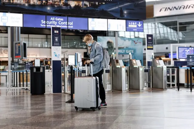 A passenger talks on the phone at Helsinki airport, Finland. File photo