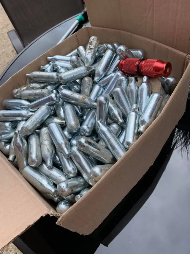 Nitrous oxide canisters in a box