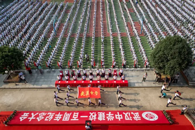 Students attend the 100th anniversary of the founding of Wuhan High School on the first day of the new semester in Wuhan in China's central Hubei province on 1 September 2020