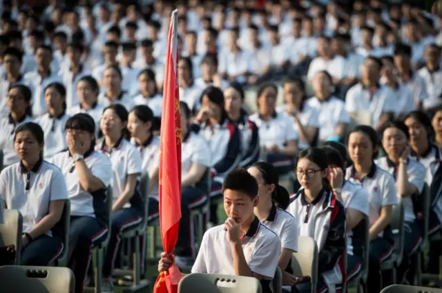 Students attend an opening ceremony in a school in Wuhan, China