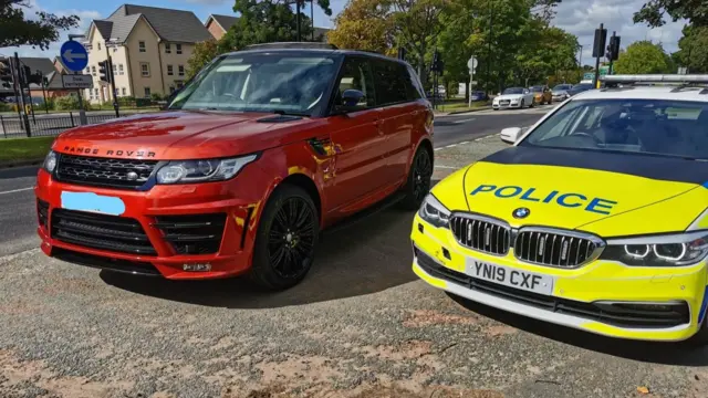 The Range Rover and a police car