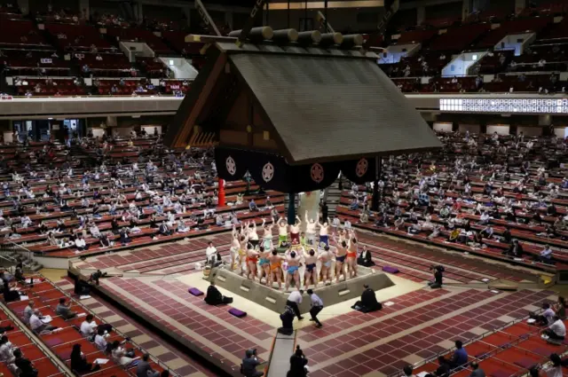 Sumo wrestlers hold a ring-entering ceremony at the Grand Sumo Tournament at Tokyo's Ryogoku Kokugikan arena. Photo: July 2020