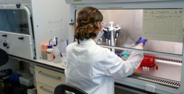 A scientist works at the Oxford Vaccine Group's facility in Oxford, the UK. File photo