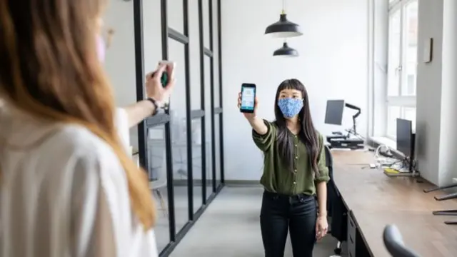 Women in mask with mobile phone