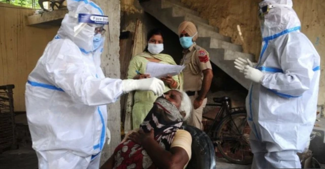 A woman getting tested by health workers in India