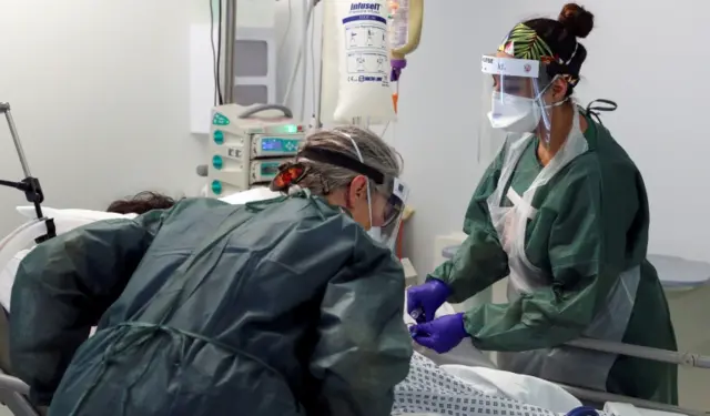 Nurses care for a patient in an Intensive Care ward treating victims of the coronavirus disease in Surrey