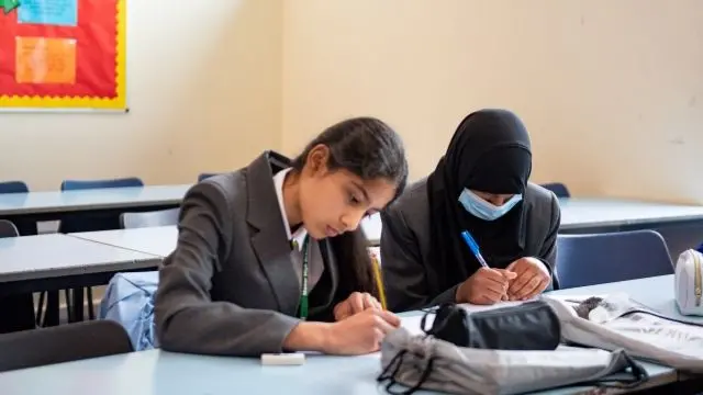 Children with face coverings in a classroom in England