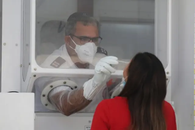 A woman undergoes a coronavirus test at the Magen David Adom position in Jerusalem, 06 September 2020.