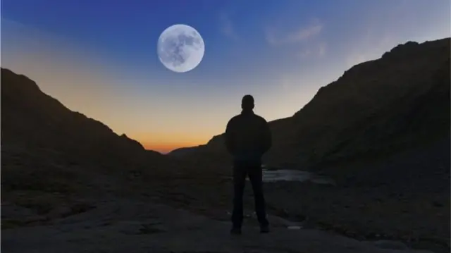 A man staring at a moon